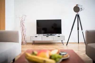 a living room with a television and a plate of fruit at Bohéme Apartments Old Town Square in Prague