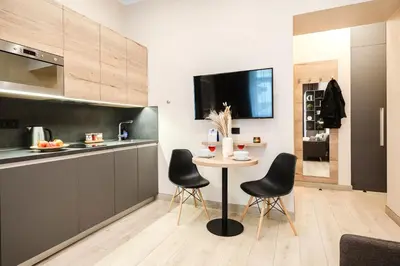 a kitchen with a table and chairs in a room at Prague Days - Modern Studios - 7 min Wenceslas Square in Prague