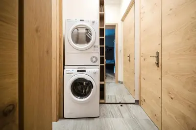 a laundry room with a washer and dryer at Prague Days - Modern Studios - 7 min Wenceslas Square in Prague