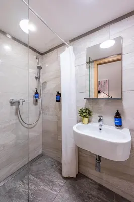 a bathroom with a sink and a shower at Prague Days - Modern Studios - 7 min Wenceslas Square in Prague