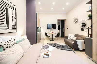 a living room with a bed and a couch at Prague Days - Modern Studios - 7 min Wenceslas Square in Prague