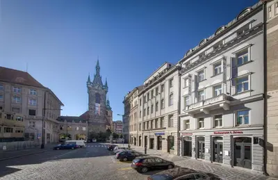 a city street with buildings and a clock tower at Hotel Essence in Prague