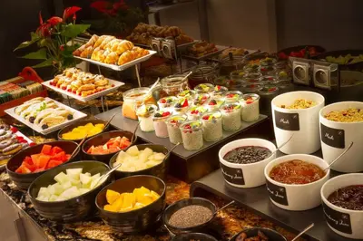 a buffet with different types of food on a table at Hotel Essence in Prague