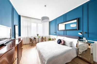 a bedroom with blue walls and a large bed at Bohéme Apartment Wenceslas Square in Prague
