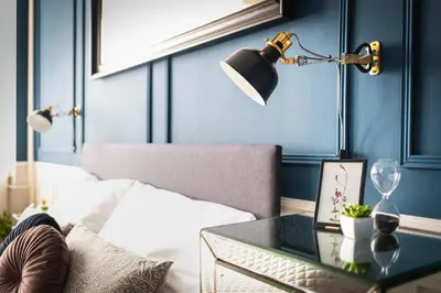 a bedroom with a bed and a table with a lamp at Bohéme Apartment Wenceslas Square in Prague