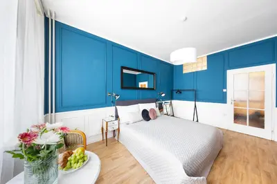 a bedroom with blue walls and a bed with a plate of fruit at Bohéme Apartment Wenceslas Square in Prague
