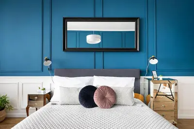 a bedroom with blue walls and a bed with pillows at Bohéme Apartment Wenceslas Square in Prague