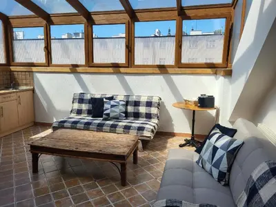 a living room with two couches and a coffee table at Sunflower Prague Apartments and suites in Prague