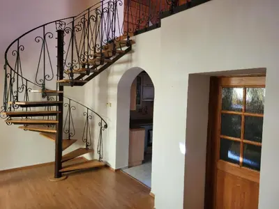 a spiral staircase in a home with a wooden floor at Sunflower Prague Apartments and suites in Prague