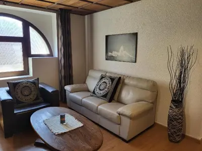 a living room with a couch and a table at Sunflower Prague Apartments and suites in Prague