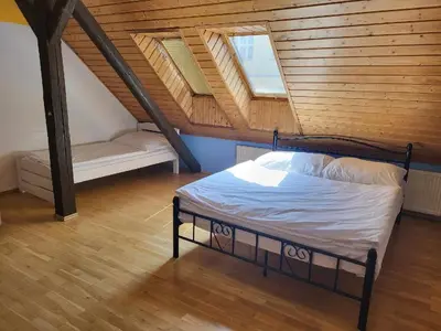 a bedroom with a bed with a wooden ceiling at Sunflower Prague Apartments and suites in Prague