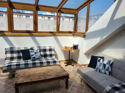 a living room with a couch and a table at Sunflower Prague Apartments and suites in Prague