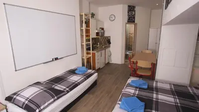 a bedroom with two beds and a chalkboard on the wall at School Apartment - Your Unique Place in Prague by metro Vyšehrad in Prague