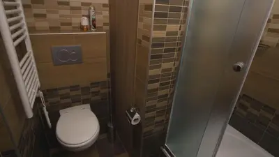 a small bathroom with a toilet and a shower at School Apartment - Your Unique Place in Prague by metro Vyšehrad in Prague