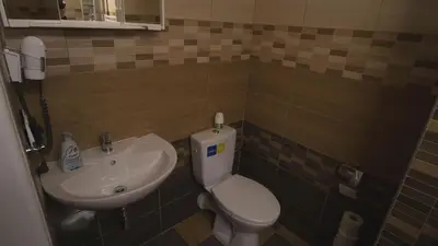 a small bathroom with a toilet and a sink at School Apartment - Your Unique Place in Prague by metro Vyšehrad in Prague