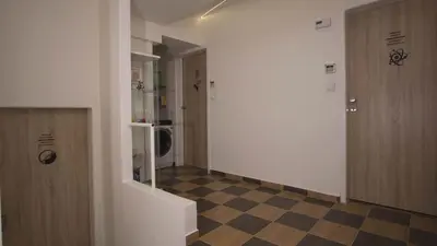a hallway with a checkered floor in a building at School Apartment - Your Unique Place in Prague by metro Vyšehrad in Prague