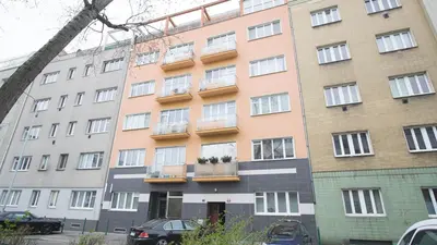 a tall building with windows and balconies on it at School Apartment - Your Unique Place in Prague by metro Vyšehrad in Prague