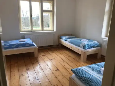 a room with two beds and two windows at Dvůr bude in Osečany