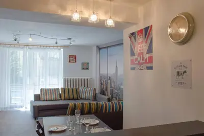 a living room with a couch and a table at Dlouha Apartment 2BD in Prague