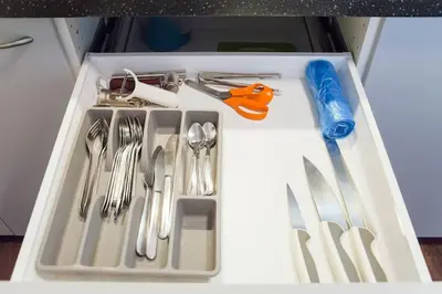 a tray filled with utensils in a drawer at Dlouha Apartment 2BD in Prague