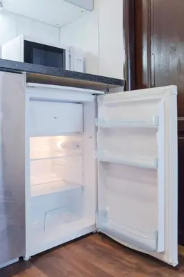 an empty refrigerator with its door open in a kitchen at Dlouha Apartment 2BD in Prague