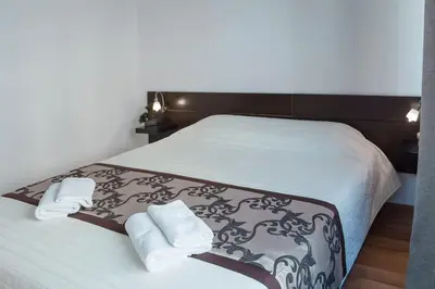 a bedroom with a large bed with towels on it at Dlouha Apartment 2BD in Prague