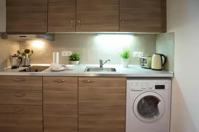 a kitchen with a washing machine and a sink at Residence Krakovska 5 in Prague