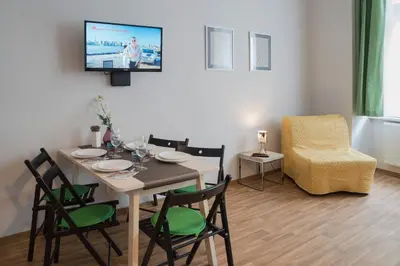a dining room with a table and chairs and a tv at Residence Krakovska 5 in Prague