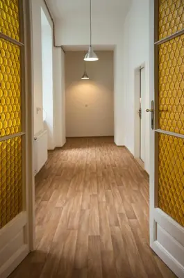 an empty hallway with wood floors and doors at Residence Krakovska 5 in Prague