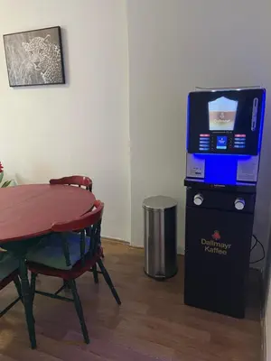 a room with a table and a television on a box at Hostel Jasmin in Prague