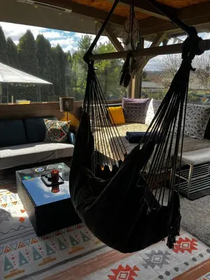 a ping pong table with two chairs and an umbrella at Glamping Karavan u Konopiště in Chrášťany