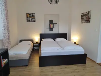 two beds in a bedroom with two lamps on tables at Stará Sázava in Sázava