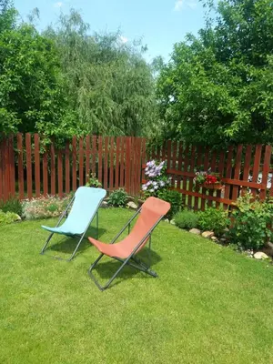 two chairs sitting in the grass in a yard at Stará Sázava in Sázava