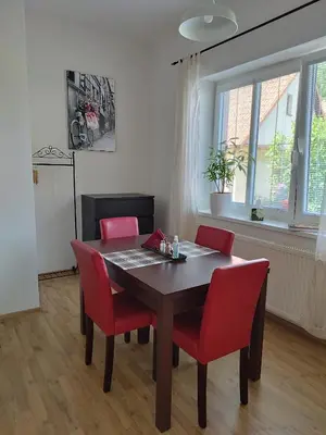 a dining room with a table and red chairs at Stará Sázava in Sázava
