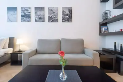 a living room with a door open to a room at Luxury Apartment on Old Town Square in Prague