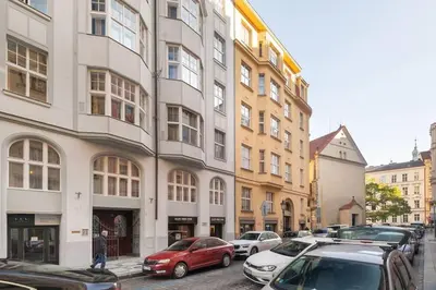 a street with cars parked in front of buildings at Luxury Apartment on Old Town Square in Prague