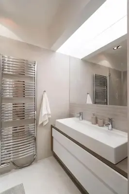 a white bathroom with a sink and a mirror at Luxury Apartment on Old Town Square in Prague