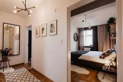 a bedroom with a large bed and a mirror at Loft apartment with balcony in centre in Prague