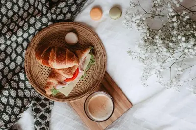 a sandwich in a basket next to a cup of coffee at Loft apartment with balcony in centre in Prague