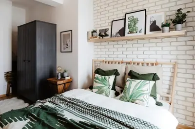 a bedroom with a bed with green and white pillows at Loft apartment with balcony in centre in Prague