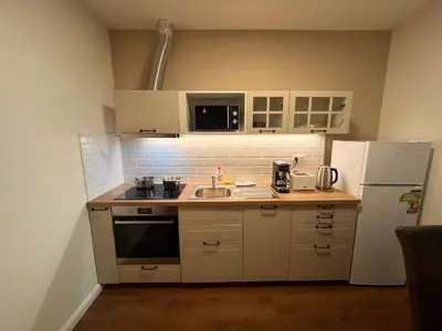 a small kitchen with a sink and a refrigerator at Riverbridge Apartments Prague in Prague