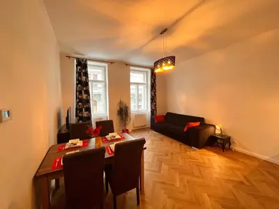 a living room with a table and a couch at Riverbridge Apartments Prague in Prague