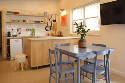 a kitchen with a table and chairs in a kitchen at Apartmán Marmeláda in Čtyřkoly