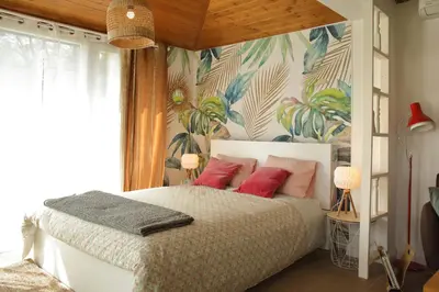 a bedroom with a large bed with pink pillows at Apartmán Marmeláda in Čtyřkoly