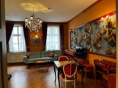 a living room with a couch and a painting on the wall at Le Papillon de Bohème in Prague