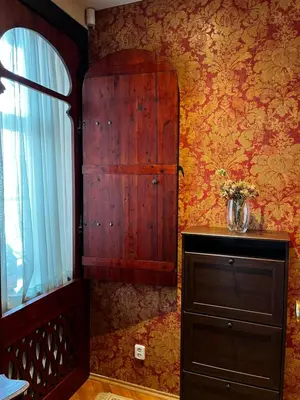 a bedroom with a wooden cabinet and a dresser with a window at Le Papillon de Bohème in Prague