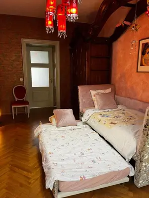 a bedroom with two beds and a chandelier at Le Papillon de Bohème in Prague