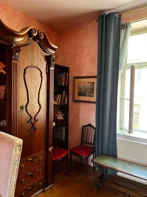 a bedroom with a bed and a window and a chair at Le Papillon de Bohème in Prague