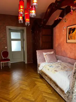 a bedroom with a bed and a chair in it at Le Papillon de Bohème in Prague