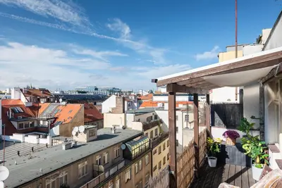 a view of the city from the balcony of a building at Castle View Apartment Prague in Prague